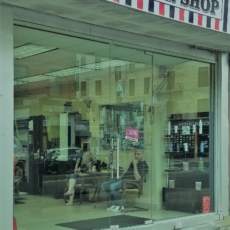 Glass storefront with cement pillar